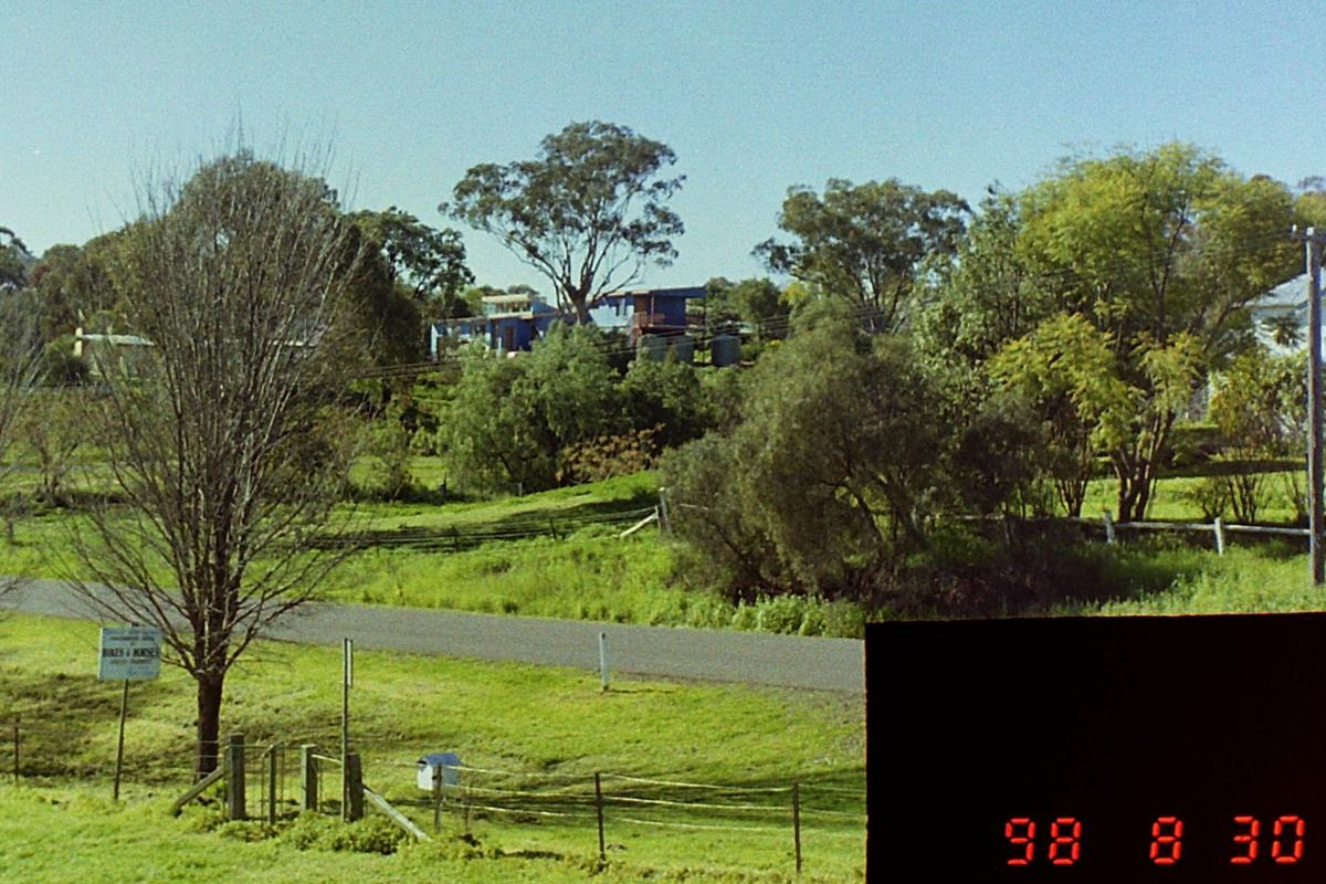 Distant view of house clad in blue