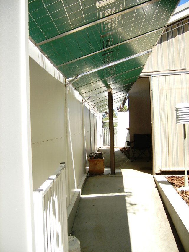 Sun mirror panels that warm the house in winter, shade the courtyard in summer.