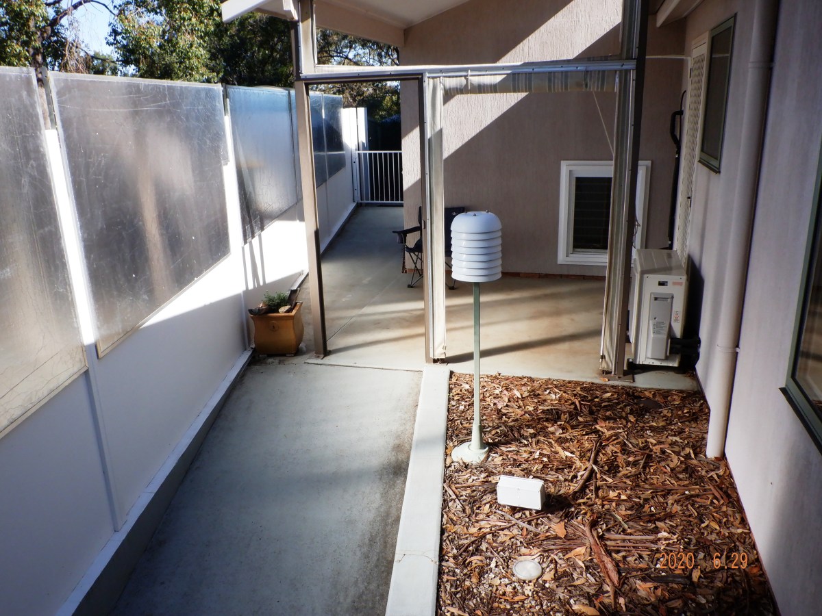 By 12.35 sun mirrors spread light to the floor of the patio and courtyard and the laundry wall.